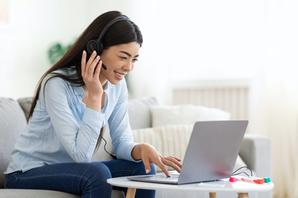 asian-woman-studying-foreign-languages-online-with-laptop-and-headset-at-home.jpg